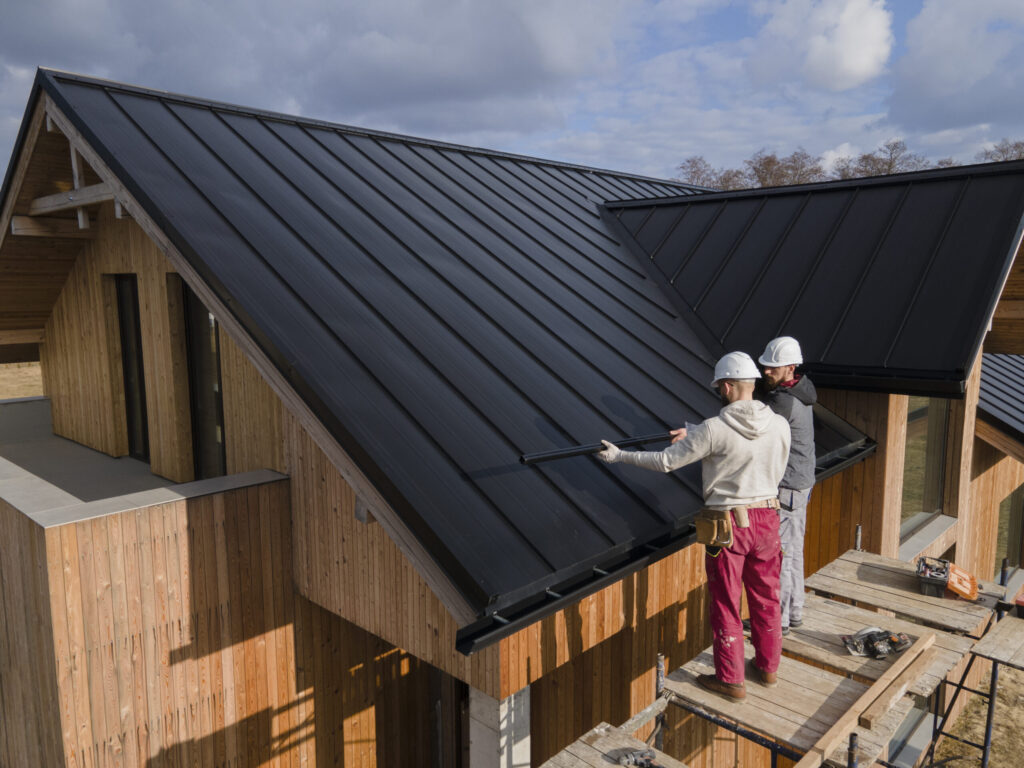 full shot roofers working together with helmets scaled.jpg